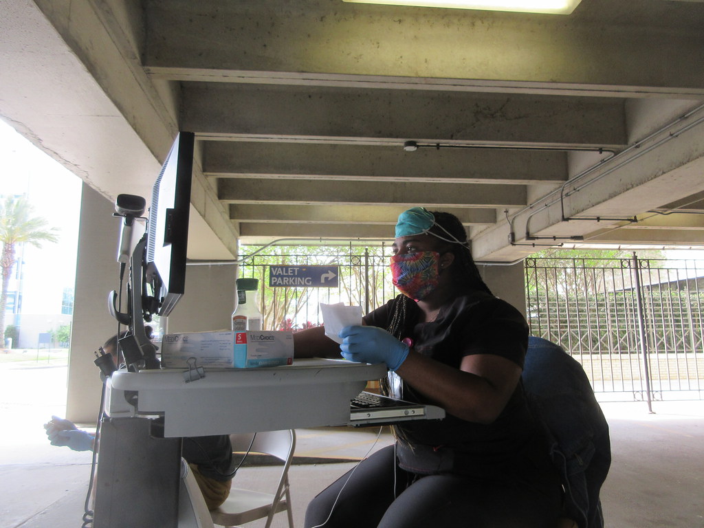 Healthcare worker preparing a prescription pickup at a service station